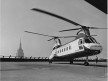 New York Airways helicopter atop Pan Am Building,with Empire State Building in background